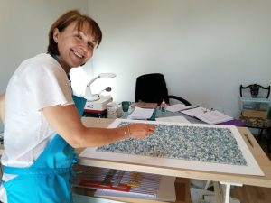 Student working on a glass splashback.